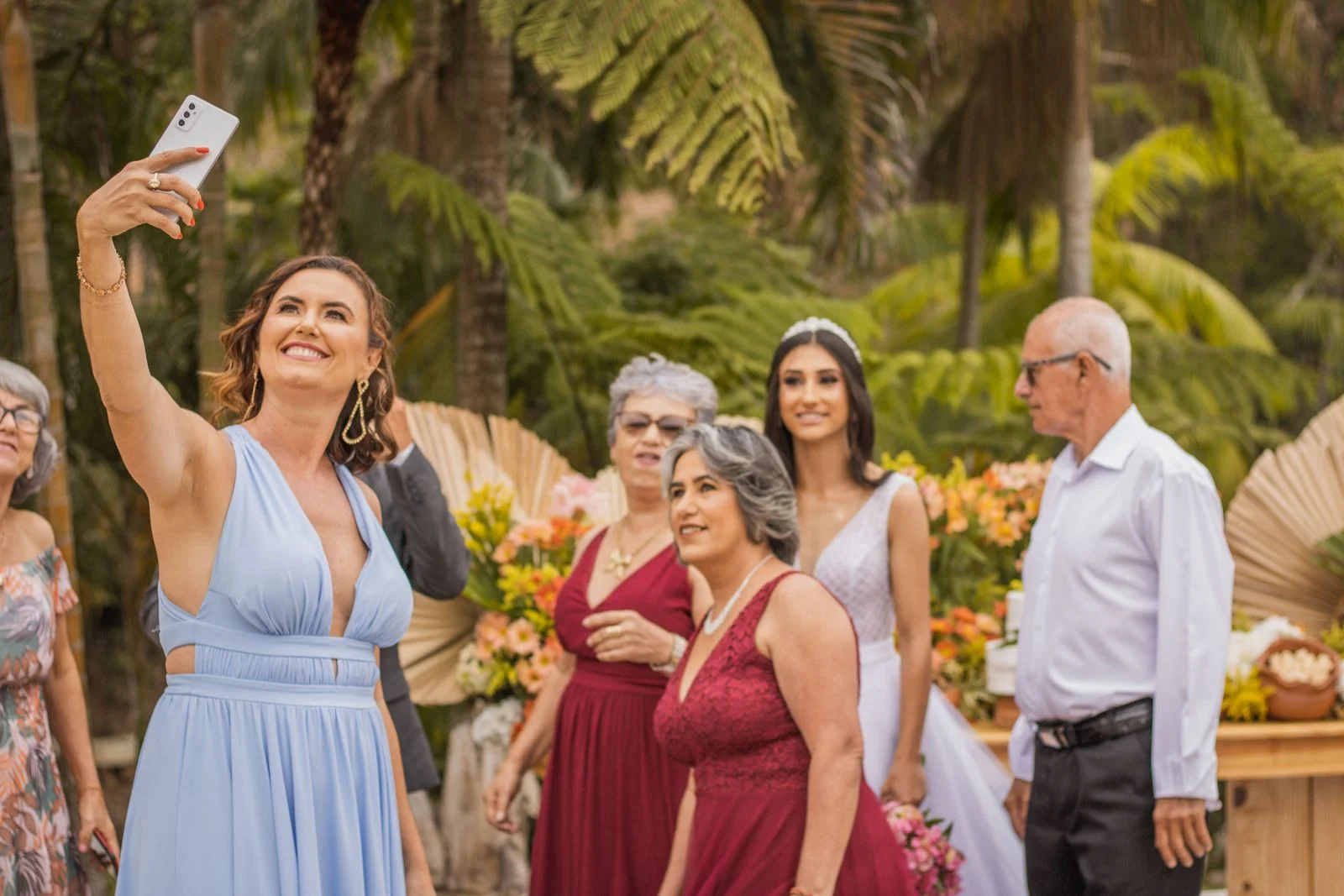 Bride and wedding guests taking a group selfie